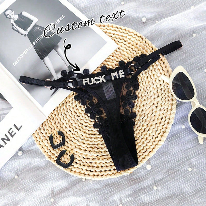 Flat lay view of custom text lace G-string panties with customizable rhinestone letters