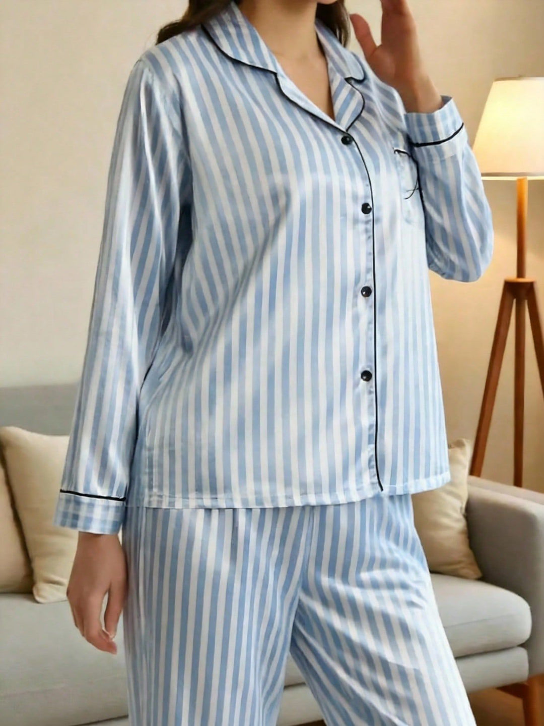 Side view fit of women's long sleeve striped satin loungewear set with classic button-down shirt